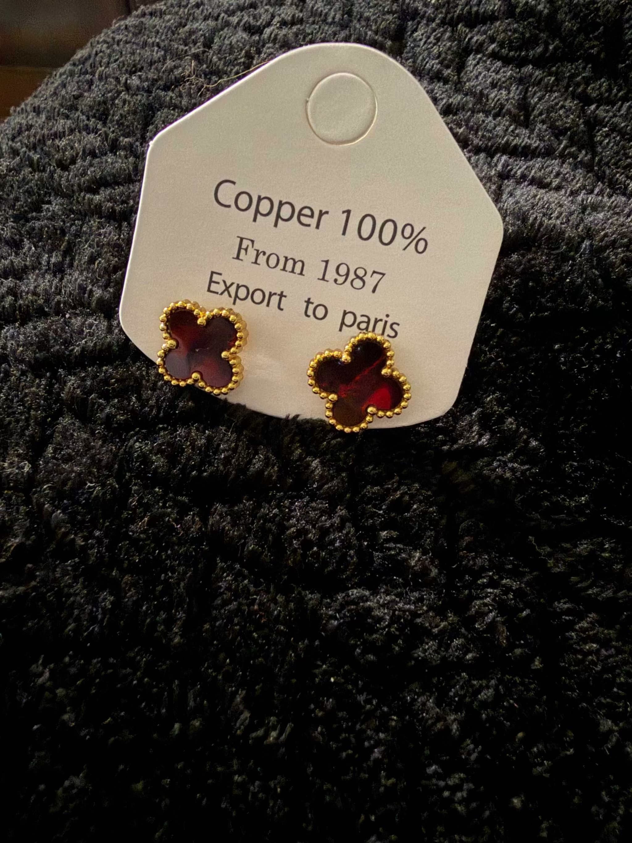 Burgundy Clover Earrings made of copper with a deep burgundy clover design and gold-tone beaded edges.